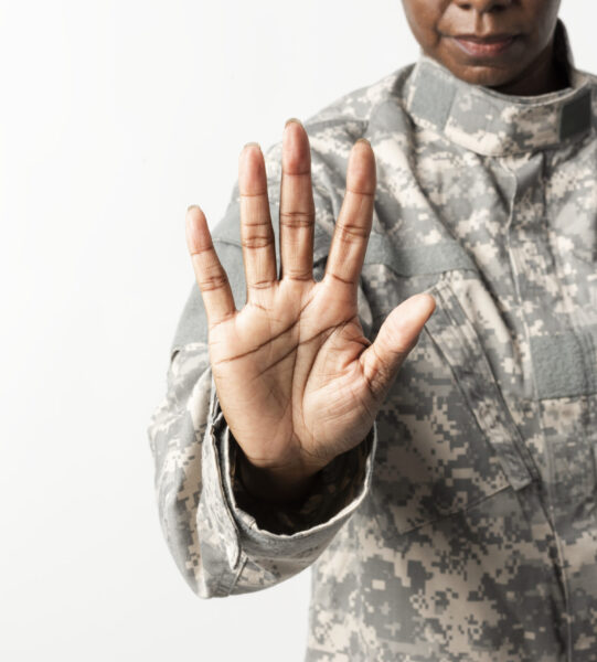 Female soldier with hand gesture